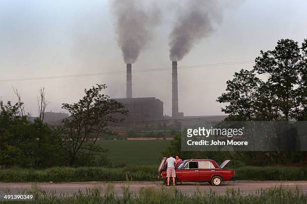 Motorists try to repair their Russian Lada on the highway near a steel production plant on May 16, 2014 in Mariupol, Ukraine. Steelworkers from the...