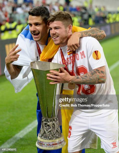 Vitolo and Alberto Moreno of Sevilla FC celebrate with the trophy after the UEFA Europa League Final between Sevilla FC and SL Benfica at Juventus...
