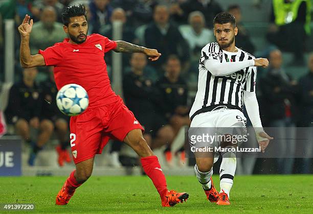 Alvaro Morata of Juventus FC is challenged by Benoit Tremoulinas of Sevilla FC during the UEFA Champions League group E match between Juventus and...