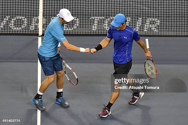 Toshihide Matsui of Japan and Jarkko Nieminen of Finland shake hands during the men's doubles first round match against Aisam-Ul-Haq Qureshi of...