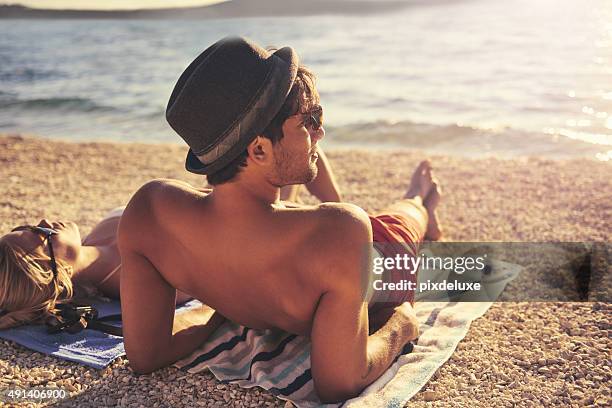 soaking up some sun - beach man stockfoto's en -beelden