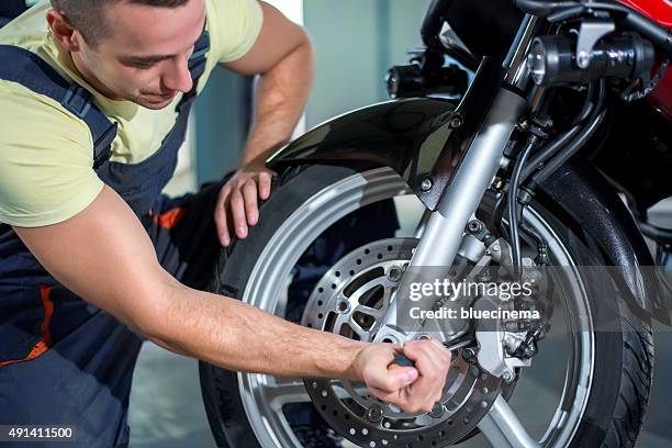 machine repairing - motorcycle tyre stock pictures, royalty-free photos & images