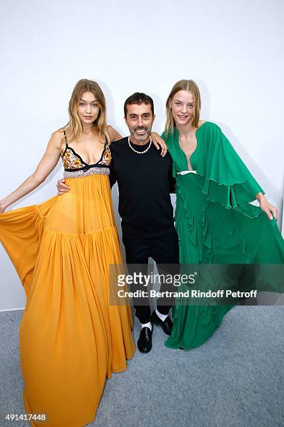 Fashion Designer Giambattista Valli poses between his Models after the Giambattista Valli show as part of the Paris Fashion Week Womenswear...