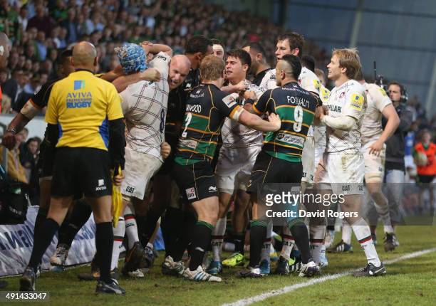 Fight breaks out between the two sides during the Aviva Premiership semi final match between Northampton Saints and Leicester Tigers at Franklin's...