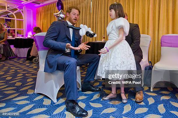 Prince Harry meets Nellie-Mai Evans winner of the Inspirational Young Person Award in the 7-10 year-old age group, as he attends the WellChild...