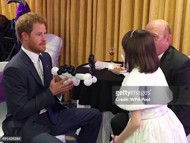 Prince Harry meets Nellie-Mai Evans winner of the Inspirational Young Person Award in the 7-10 year-old age group, and her father Jeff , as he...