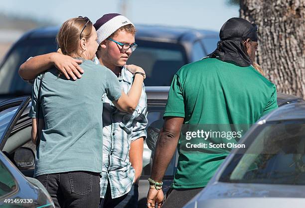 Umpqua Community College shooting survivor Mathew Downing is greeted as he arrives on campus near Snyder Hall on October 5, 2015 in Roseburg, Oregon....