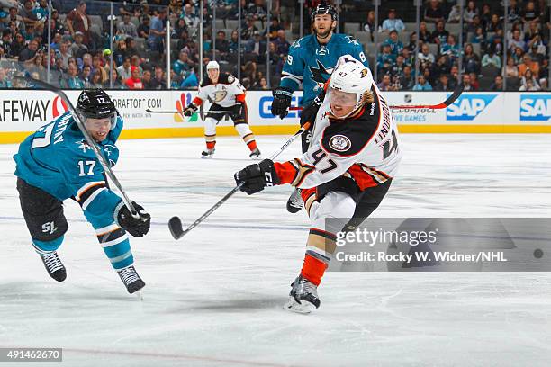 Hampus Lindholm of the Anaheim Ducks shoots the puck against John McCarthy of the San Jose Sharks at SAP Center on September 26, 2015 in San Jose,...