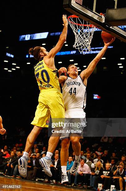 Bojan Bogdanovic of the Brooklyn Nets shoots against Luigi Datome of Fenerbahce during their Pre Season game at the Barclays Center on October 5,...