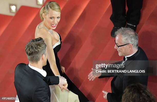 Canadian actor Ryan Reynolds and his wife US actress Blake Lively talk with the General Delegate of the Cannes Film Festival Thierry Fremaux as they...