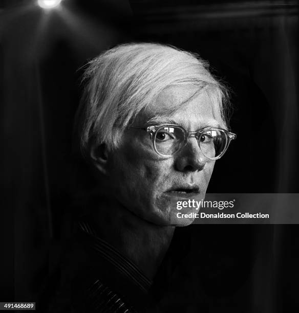 Artist Andy Warhol poses for a portrait session at the Factory in 1975 in New York, New York.