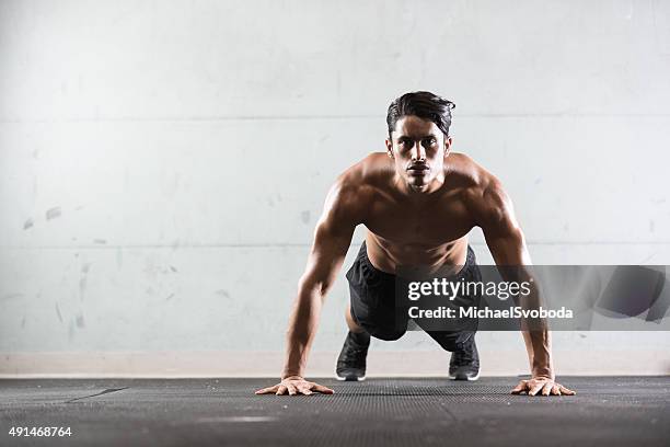 hispanic mann tun push-ups - liegestütze stock-fotos und bilder