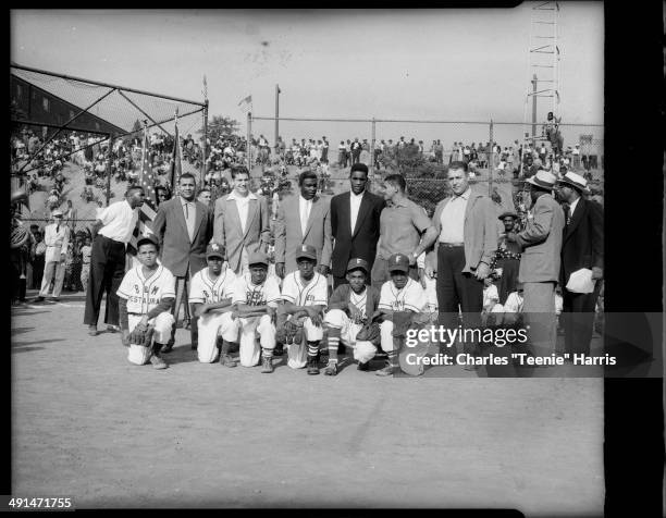 Baseball players at Uptown Little League baseball opening day ceremonies, Kennard Field, Pittsburgh, Pennsylvania, May 29, 1953. Front row from left:...