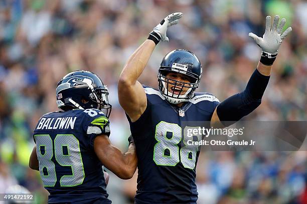 Doug Baldwin of the Seattle Seahawks celebrates with Jimmy Graham of the Seattle Seahawks after scoring a touchdown during the second quarter of a...