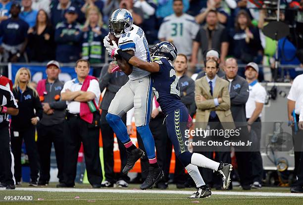 Calvin Johnson of the Detroit Lions catches a pass against Cary Williams of the Seattle Seahawks during the first half of their game at CenturyLink...