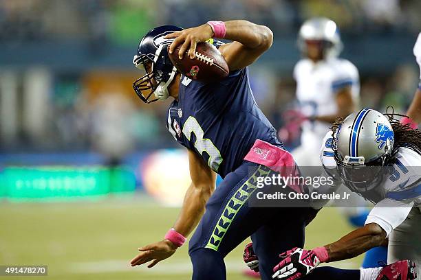 Rashean Mathis of the Detroit Lions attempts to tackle Russell Wilson of the Seattle Seahawks during the second half of their game at CenturyLink...