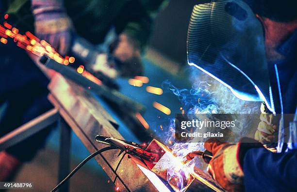 metal industry routine. - welding helmet stock pictures, royalty-free photos & images