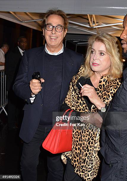Catherine Deneuve and Gilles Dufour attend the Saint Laurent show as part of the Paris Fashion Week Womenswear Spring/Summer 2016 on October 5, 2015...