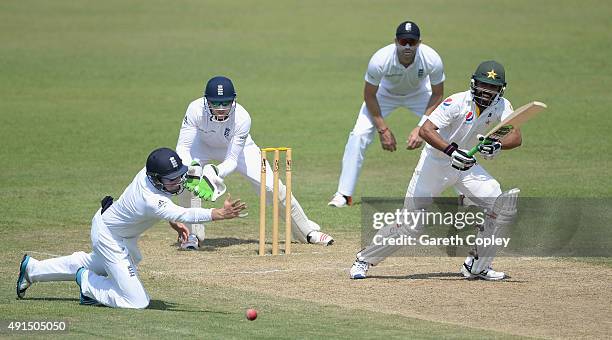 Fawad Alam of Pakistan A hits past Ian Bell of England during day two of the tour match between Pakistan A and England at Sharjah Cricket Stadium on...