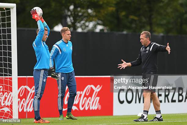 Assistant coach Andreas Koepcke talks to his players Marc-Andre ter Stegen and Bernd Leno during a training session of the German national football...