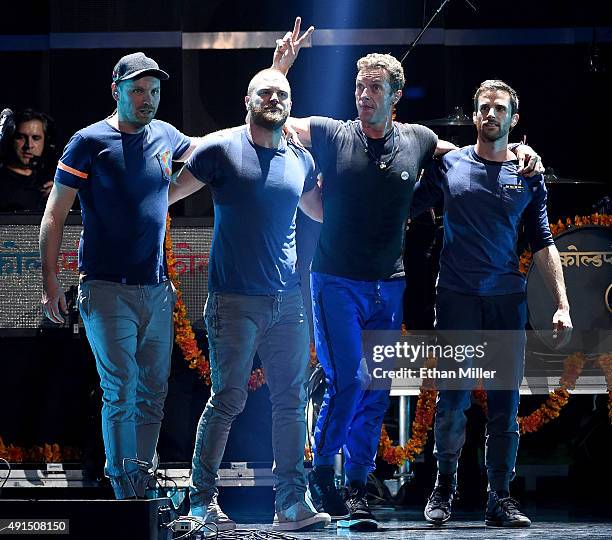 Guitarist Jonny Buckland, drummer Will Champion, frontman Chris Martin and bassist Guy Berryman of Coldplay take a bow after performing at the 2015...