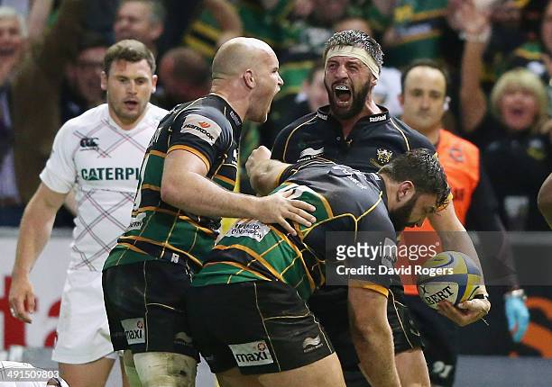 Tom Wood of Northampton Saints celebrates with team mates after scoring the last minute match winning try during the Aviva Premiership semi final...