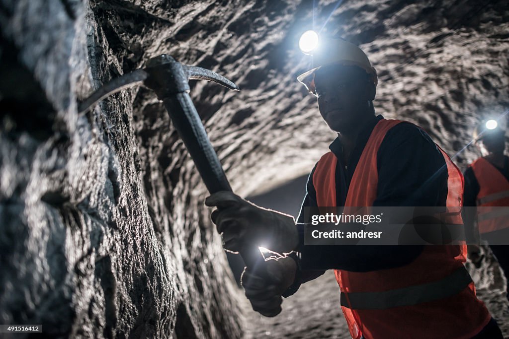 Miner using a pick tool at the mine