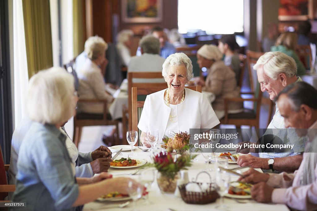 Reminiscing Group Reminiscing With Friends At The Dining Table High-Res Stock Photo ...
