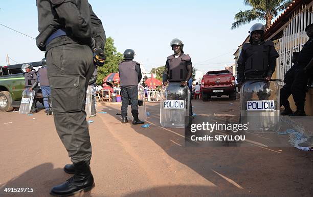 Police secure the area during the closing campaign rally for independent presidential candidate Nuno Gomes Nabiam May 16, 2014 in Bissau....