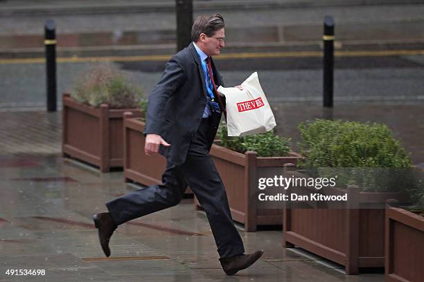 Visitors arrive in the rain for the Conservative party conference on October 6, 2015 in Manchester, England. Home Secretary Theresa May addressed...