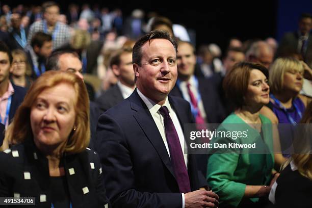 British Prime Minister David Cameron listens as London mayor Boris Johnson speaks to conference on the third day of the Conservative party conference...