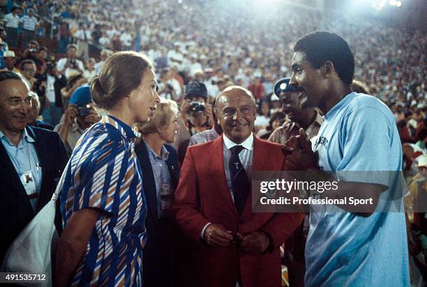Princess Anne talks with English athlete Daley Thompson of the Great Britain team after he finished in first place to set a new world and Olympic...