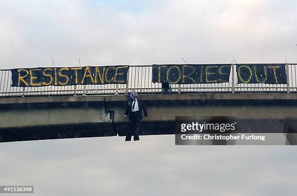 An effigy hangs from a motorway bridge as delegates make their way to the Conservative Conference in Manchester on October 6, 2015 in Manchester,...