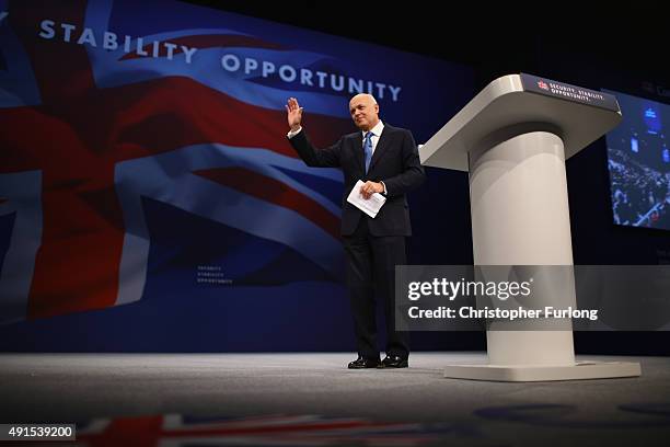 Work and Pensions Secretary Iain Duncan Smith leaves the stage after delivering his keynote speech to delegates during the Conservative Party...