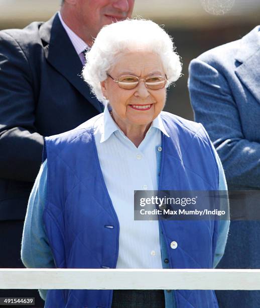 Queen Elizabeth II watches her horse 'Barber's Shop' compete in the Tattersalls and Ror Thoroughbred Ridden Show Class on day 3 of the Royal Windsor...