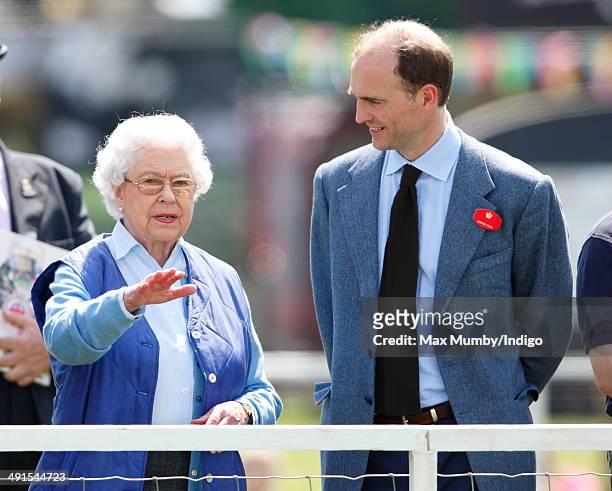Queen Elizabeth II watches her horse 'Barber's Shop' compete in the Tattersalls and Ror Thoroughbred Ridden Show Class on day 3 of the Royal Windsor...