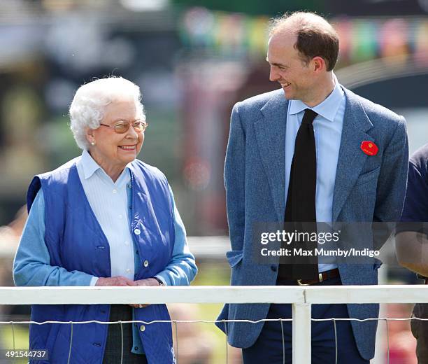 Queen Elizabeth II watches her horse 'Barber's Shop' compete in the Tattersalls and Ror Thoroughbred Ridden Show Class on day 3 of the Royal Windsor...