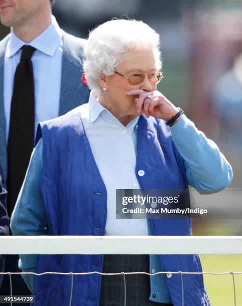 Queen Elizabeth II watches her horse 'Barber's Shop' compete in the Tattersalls and Ror Thoroughbred Ridden Show Class on day 3 of the Royal Windsor...