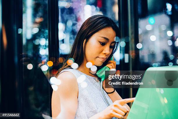 portrait of a japanese woman - pay phone stock pictures, royalty-free photos & images