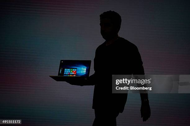 The silhouette of Panos Panay, corporate vice president of Microsoft Corp. Surface, is seen as he unveils the new Microsoft Surface Book laptop...