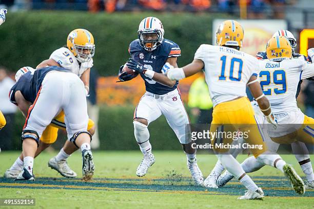 Running back Roc Thomas of the Auburn Tigers looks to maneuver by safety Maurice McKnight of the San Jose State Spartans on October 3, 2015 at...