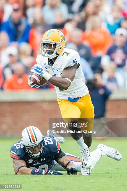 Running back Tyler Ervin of the San Jose State Spartans dodges a tackle by defensive back Tray Matthews of the Auburn Tigers on October 3, 2015 at...
