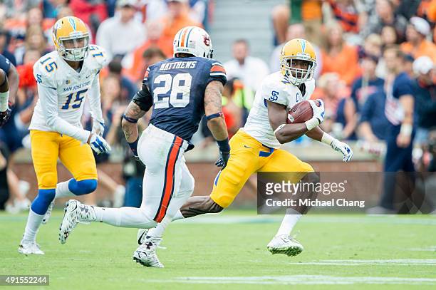Running back Tyler Ervin of the San Jose State Spartans looks to maneuver by defensive back Tray Matthews of the Auburn Tigers on October 3, 2015 at...