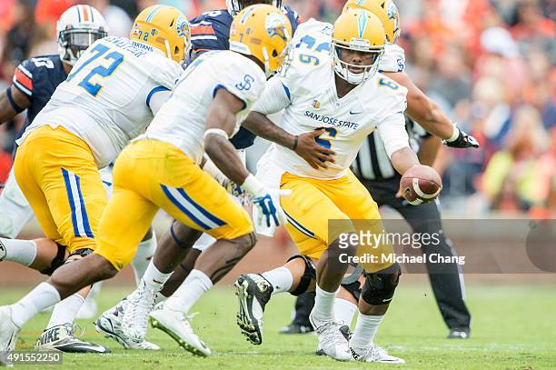 Quarterback Joe Gray of the San Jose State Spartans looks to hand the ball off to running back Tyler Ervin of the San Jose State Spartans during...