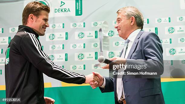 President Wolfgang Niersbach shakes hands with Dr. Felix Brych during the Referee Of The Year Awarding Ceremony at Favorite Parkhotel on October 6,...