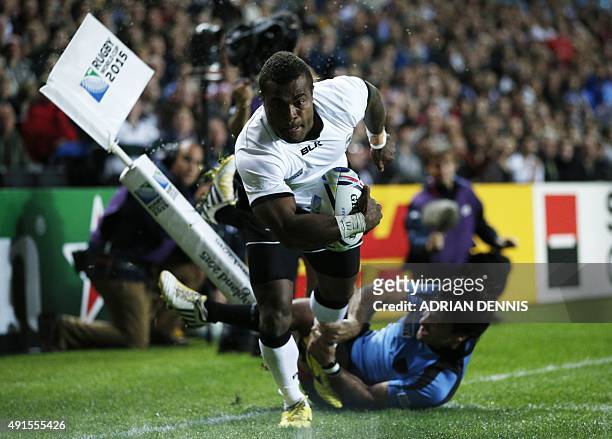 Fiji's scrum half Nemia Kenatale scores a try during a Pool A match of the 2015 Rugby World Cup between Fiji and Uruguay at Stadium MK in Milton...