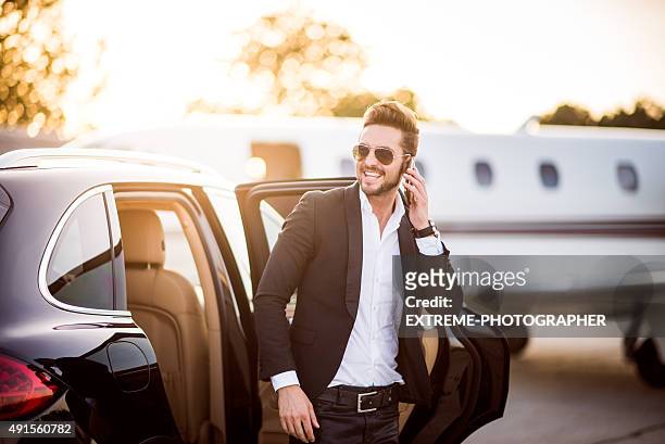 man on the airport with phone in his hand - celebrities stockfoto's en -beelden