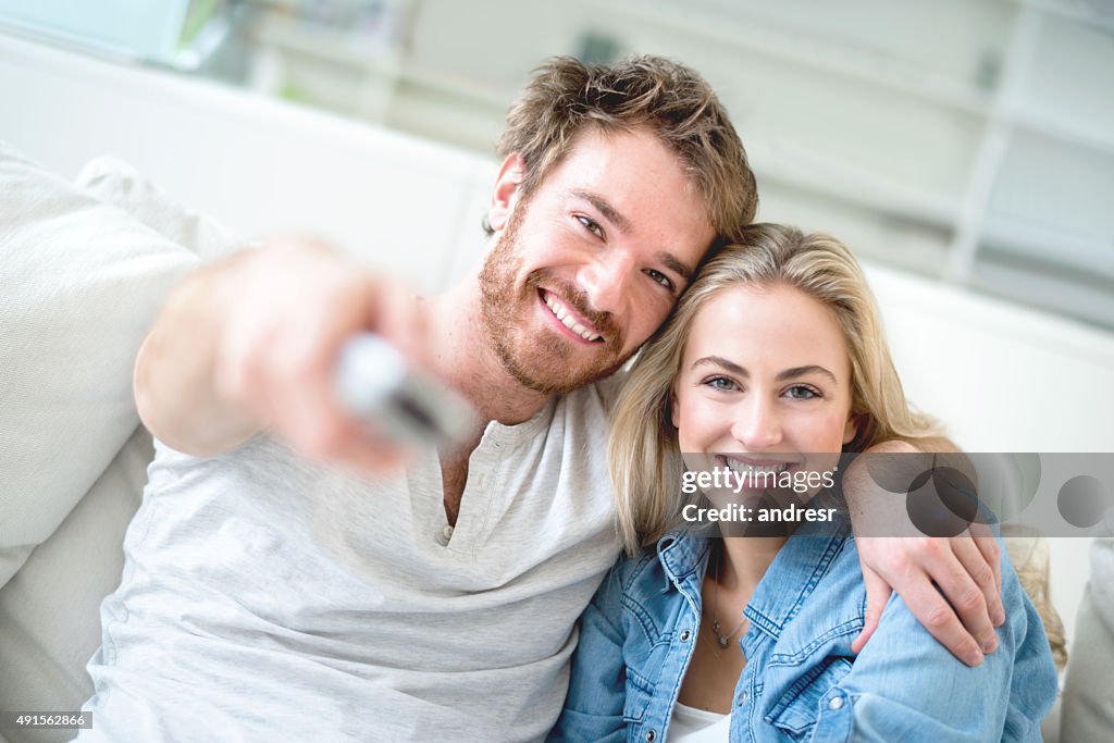 Loving couple at home watching tv