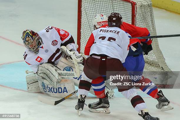 Goaltender Tomas Poepperle Sparta Prague with a save against ZSC Lions forward Fabrice Herzog during the Champions Hockey League round of thirty-two...