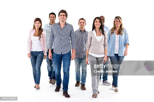 group of casual people walking - medium group of people stock pictures, royalty-free photos & images